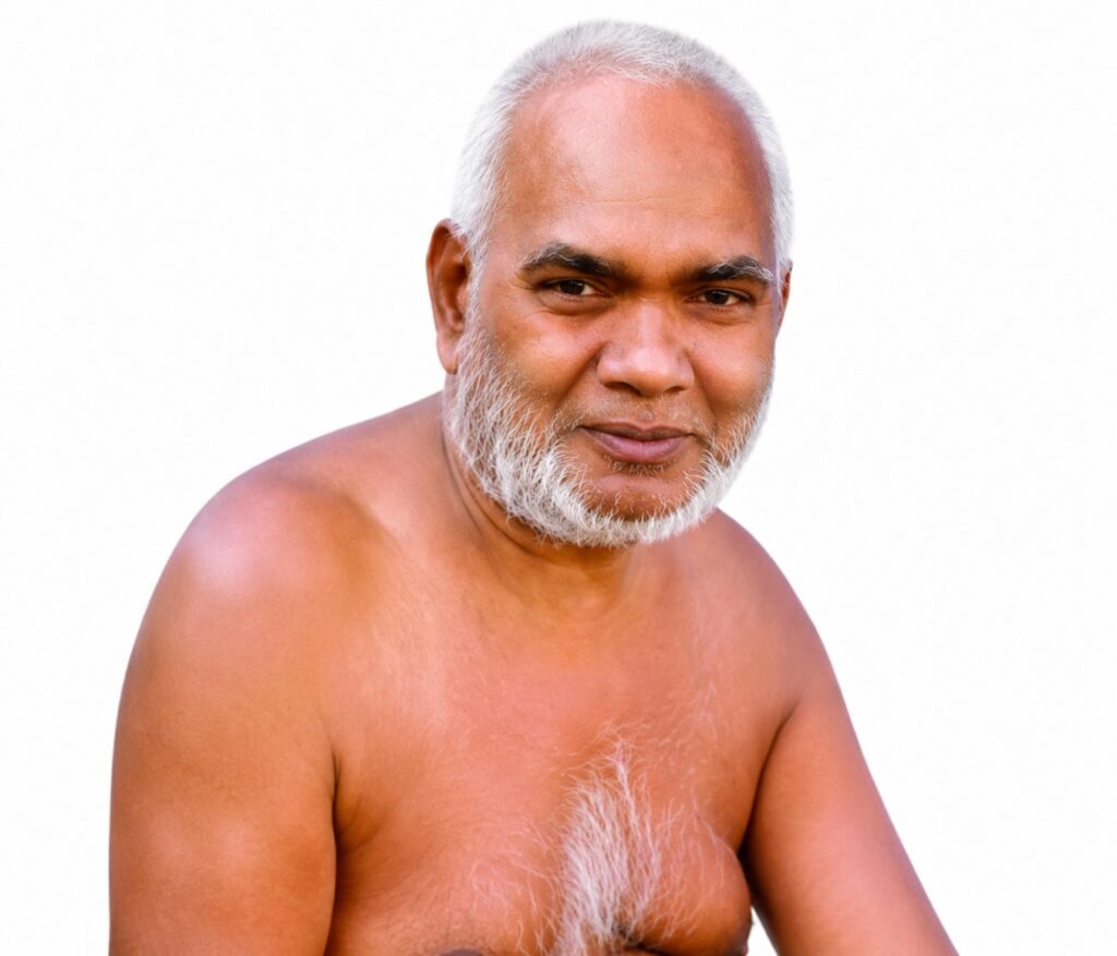 Older man with short white hair and a white beard, shirtless against a white background, looking at the camera.