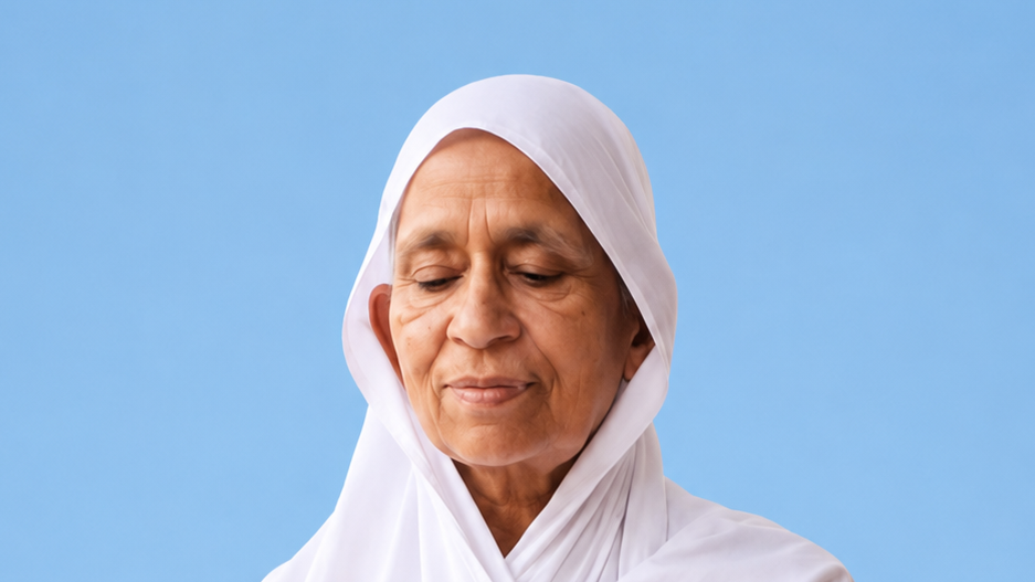 Older woman wearing a white headscarf against a light blue background, looking down with a calm expression.