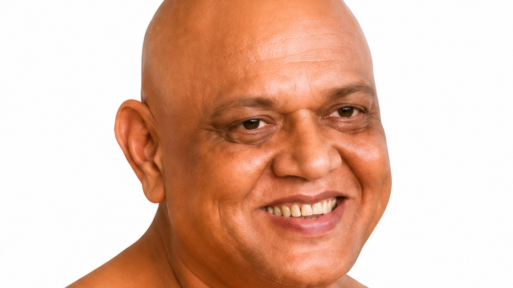 Close-up portrait of a smiling bald man against a white background.