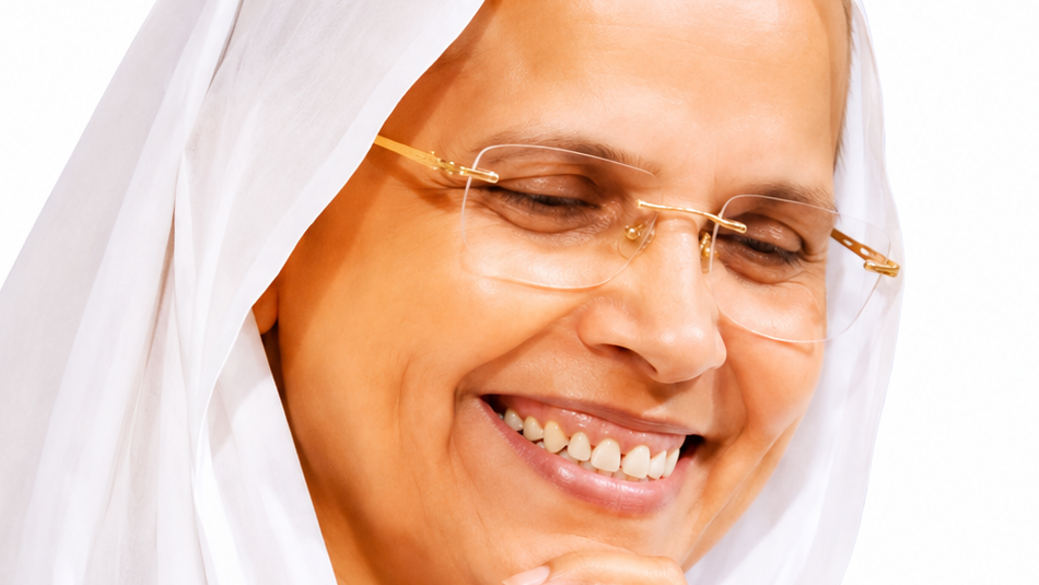 Close-up of a smiling woman wearing a white headscarf and gold-rimmed glasses, conveying warmth and happiness.