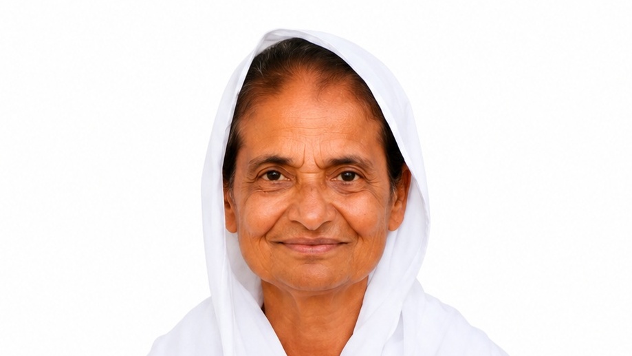 Smiling woman with tan skin wearing a white headscarf against a plain white background.