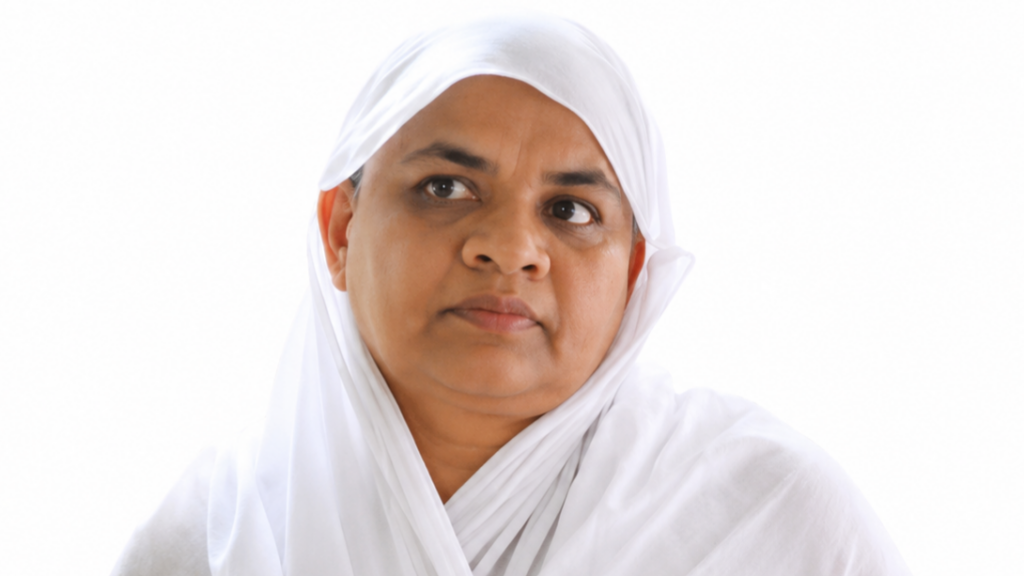 Close-up portrait of a woman wearing a white headscarf, looking to the left against a white background.
