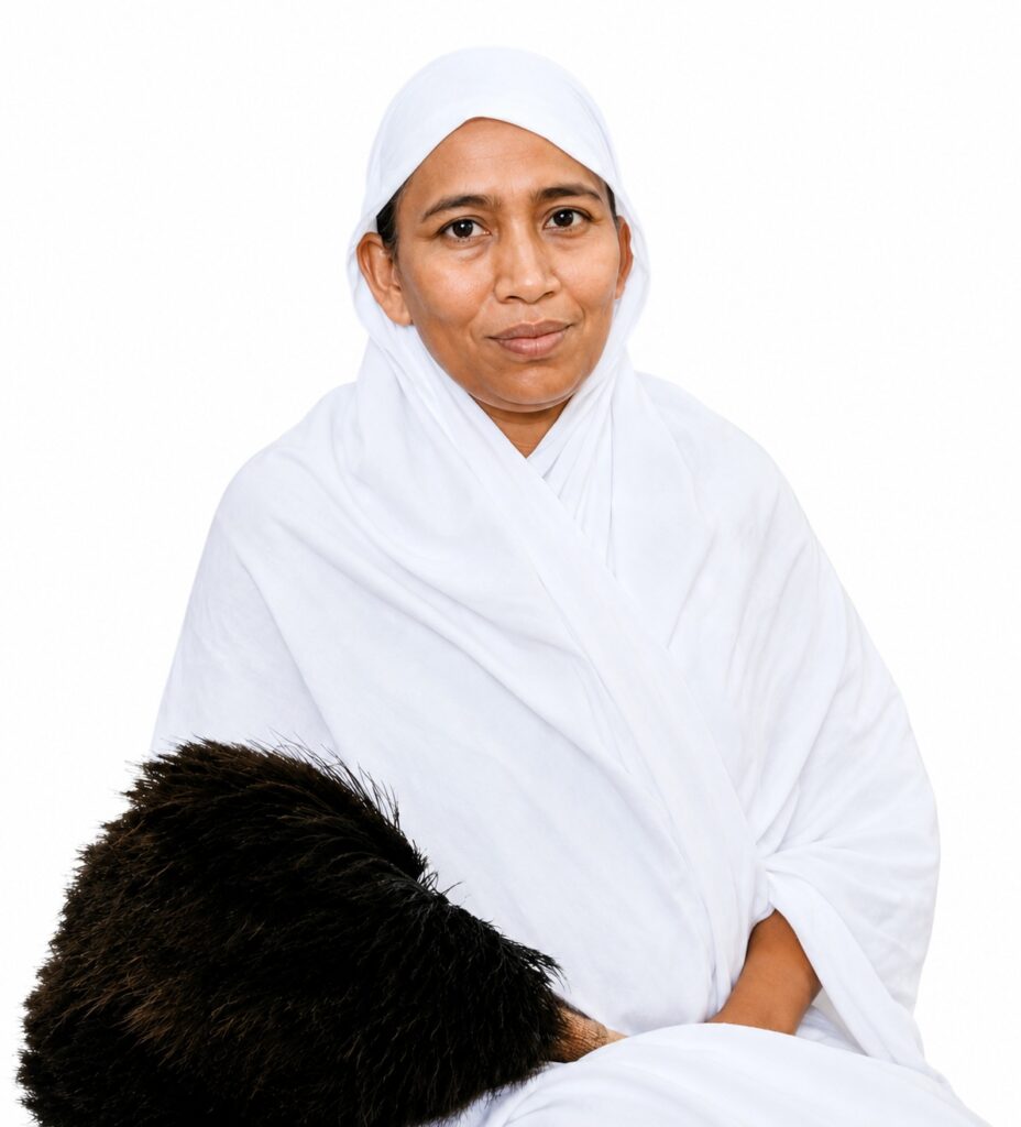 Woman in a white hijab holding a dark brown fur object in her arms.