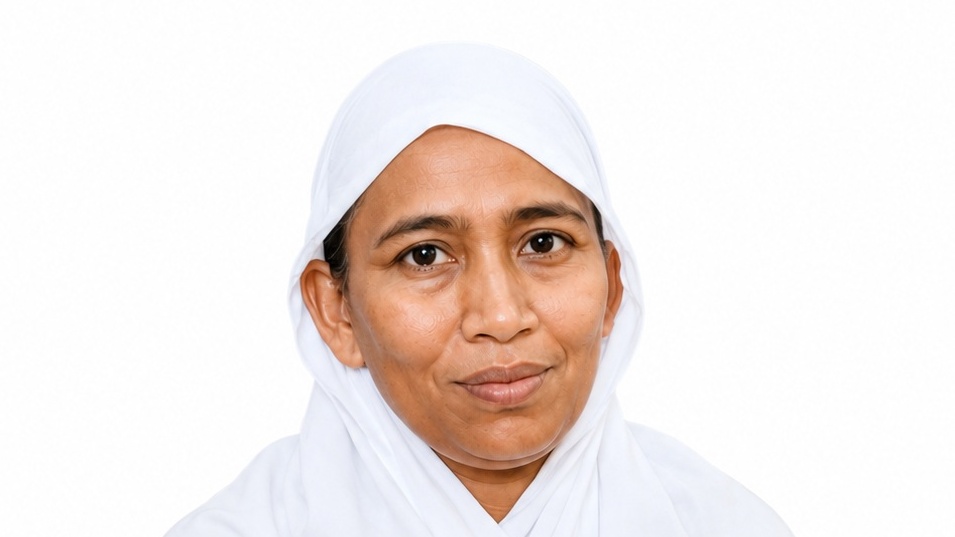 Portrait of a woman in a white hijab facing the camera with a soft smile.