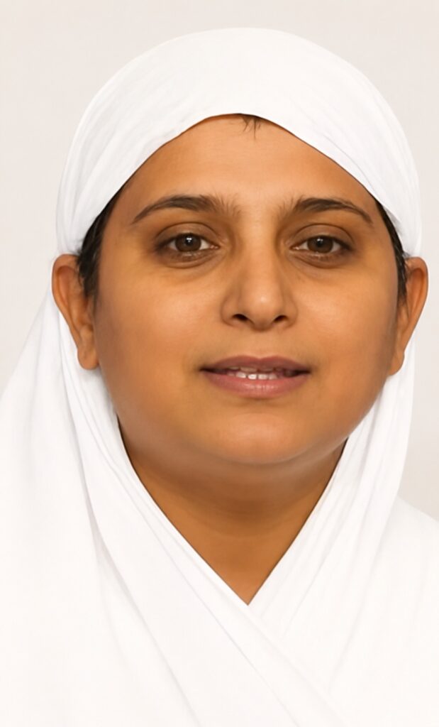Close-up of a woman wearing a white hijab, facing the camera with a calm, neutral expression.