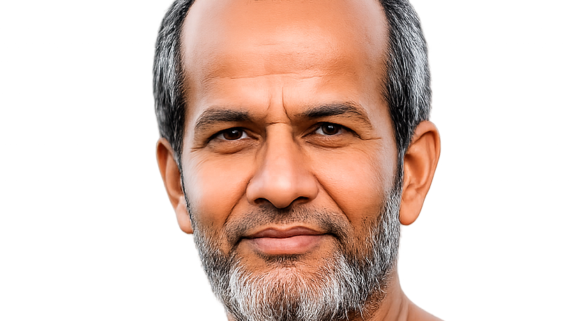 Close-up portrait of a middle-aged man with salt-and-pepper hair and beard, smiling softly at the camera