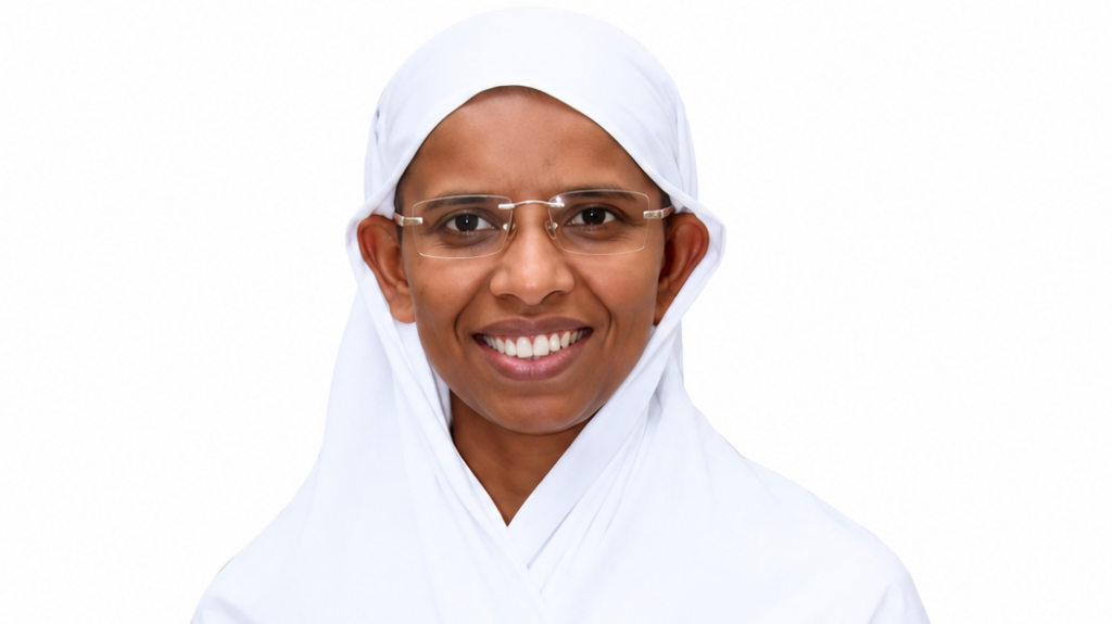Smiling woman wearing a white hijab and glasses against a white background.