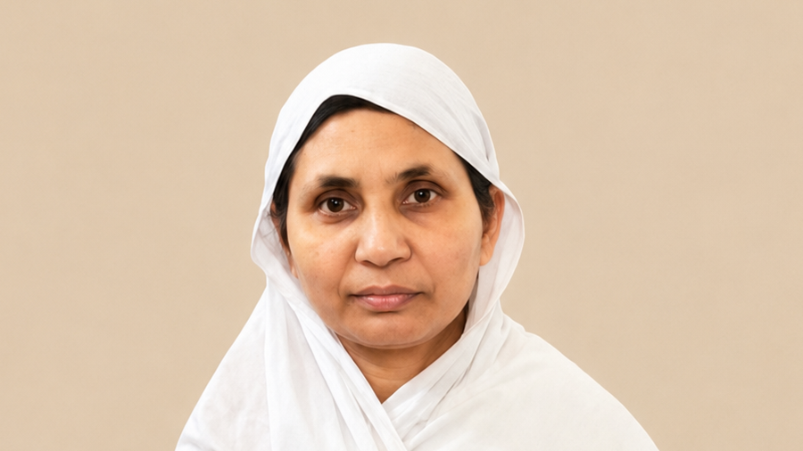 Portrait of a woman wearing a white headscarf, facing the camera with a neutral expression.