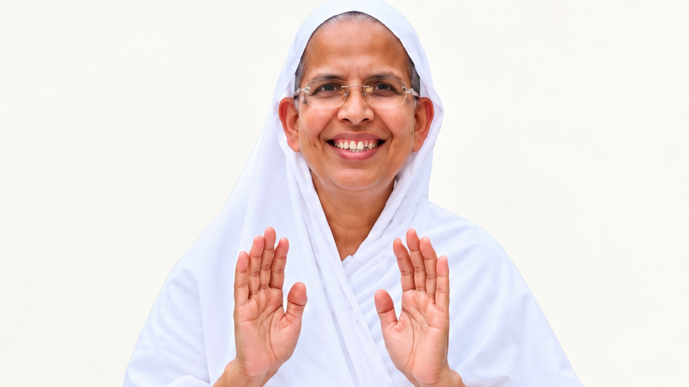 Smiling nun in a white habit raises both hands in a welcoming gesture.