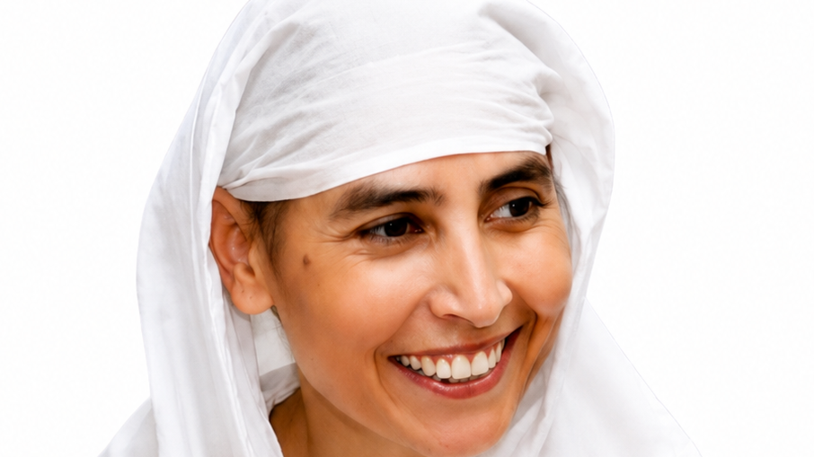 Smiling woman wearing a white headscarf against a white background.