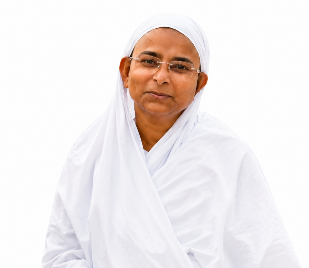 Portrait of a person in white traditional attire with a headscarf and glasses, looking softly at the camera with a gentle smile.