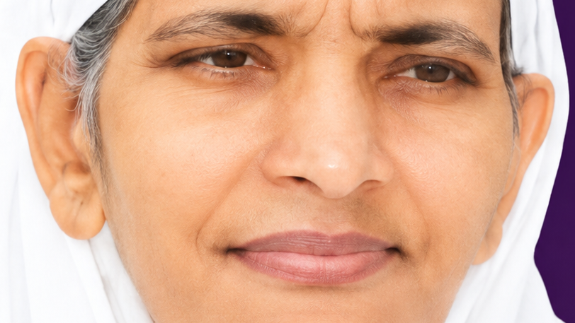 Close-up of a calm woman with light brown skin wearing a white headscarf, looking to the side.