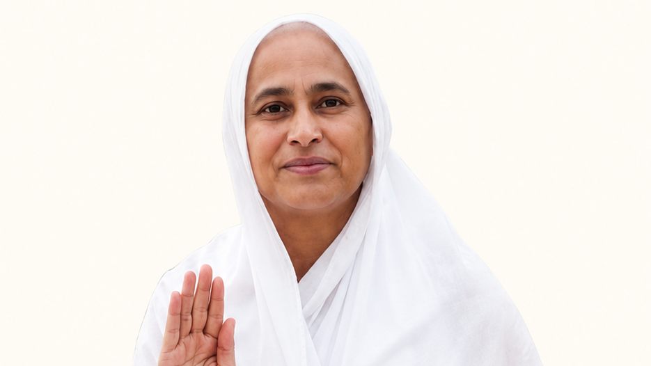 Woman in a white hijab raises her hand in a greeting with a gentle smile on her face.