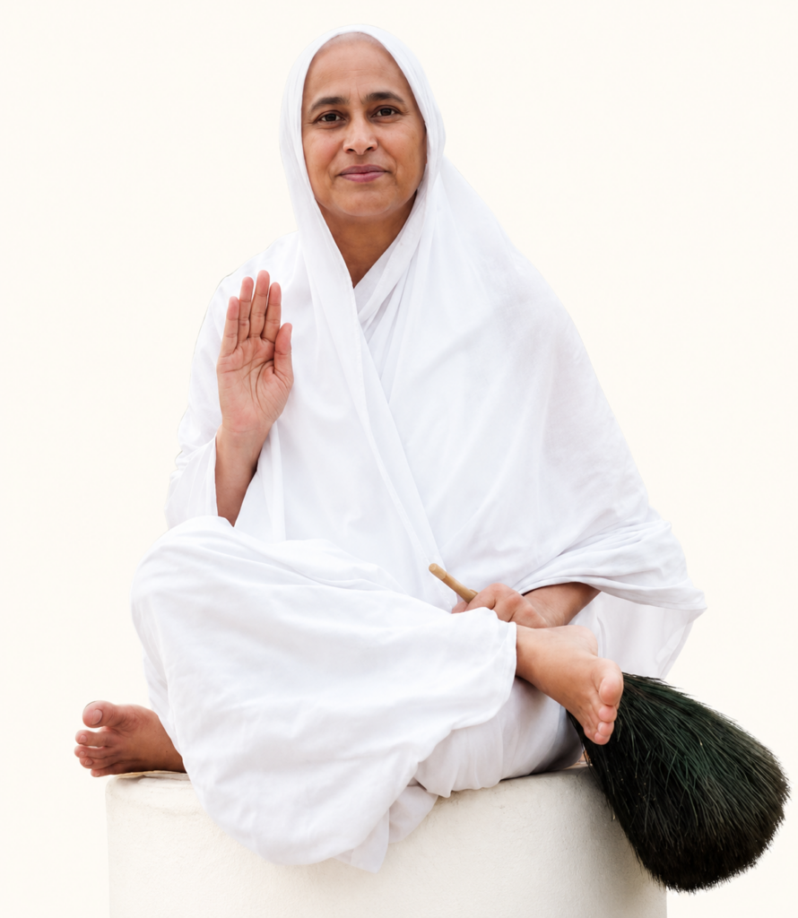 Woman in white robes sits cross-legged on a pedestal, raising her right hand in blessing and holding a broom nearby.