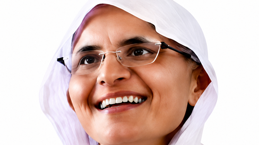 Smiling woman wearing a white headscarf and glasses, looking slightly upward and joyful.