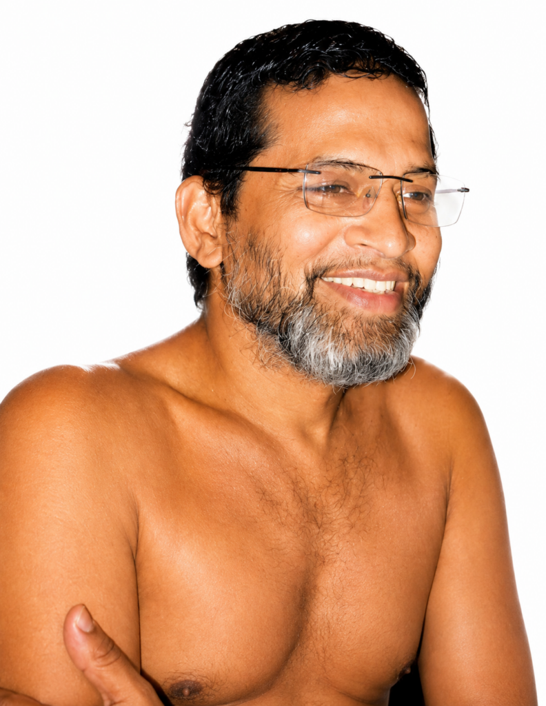 Smiling man with glasses and gray beard, shirtless, against a white background, looking to the right.