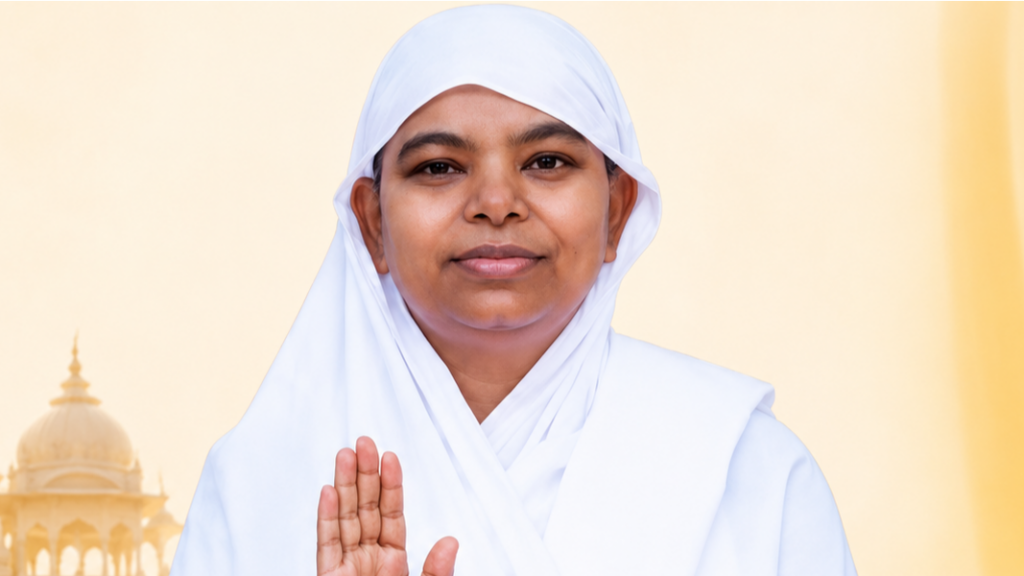 Woman in a white headscarf and robe, smiling with one hand raised in blessing against a pale yellow background.