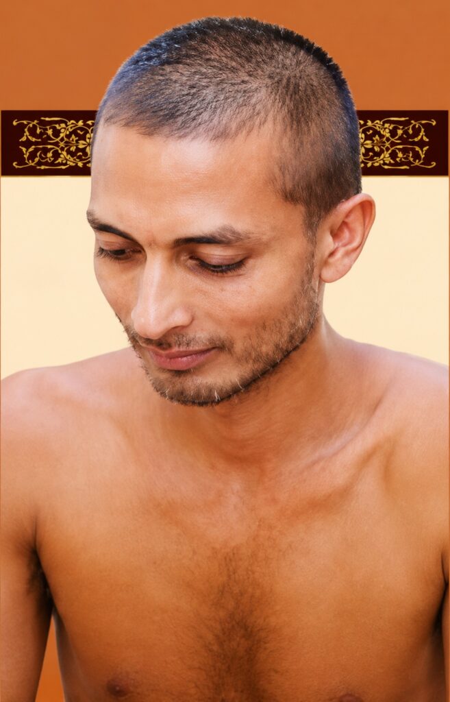 Portrait of a shirtless man with a buzz cut looking down against an orange-beige background, subtle facial stubble visible.