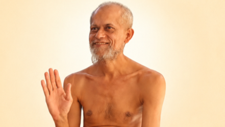 Older shirtless man with a gray beard waves hello against a pale background.