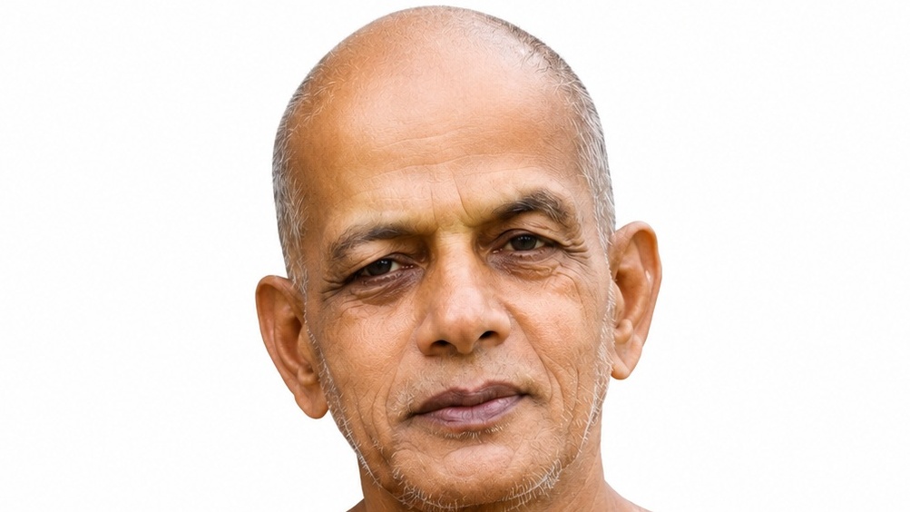 Close-up portrait of a middle-aged man with a bald head and light stubble, neutral expression, against a white background.