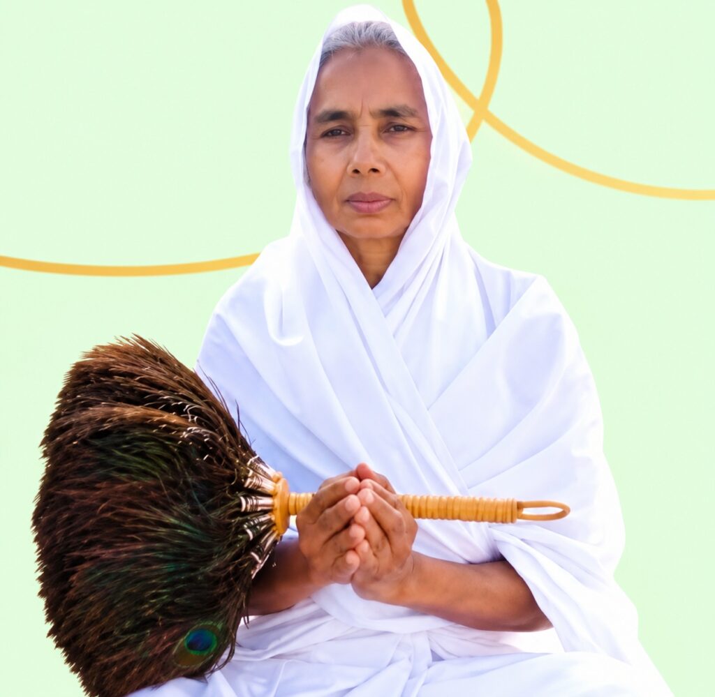 Elder woman in a white robe holds a large brown feather broom with a wooden handle against a pale green background.