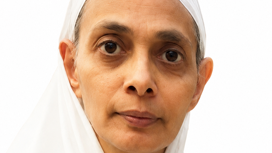 Close-up portrait of a woman in a white headscarf, looking at the camera against a white background.