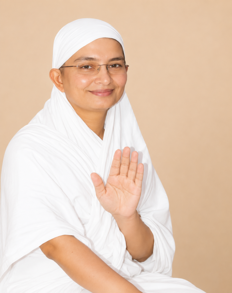Smiling woman in a white headscarf and glasses holds up her open hand in a stop gesture toward the camera.