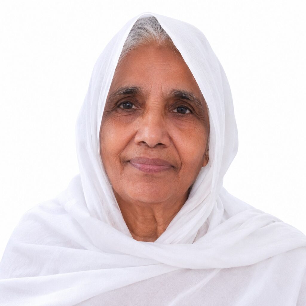 Close-up portrait of an elderly woman wearing a white headscarf, smiling softly at the camera.