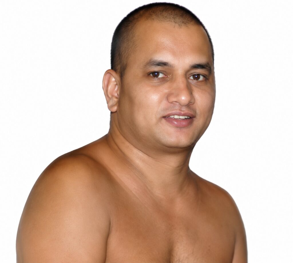 Close-up portrait of a shirtless man with short hair, facing slightly to the right, and a subtle smile against a white background.