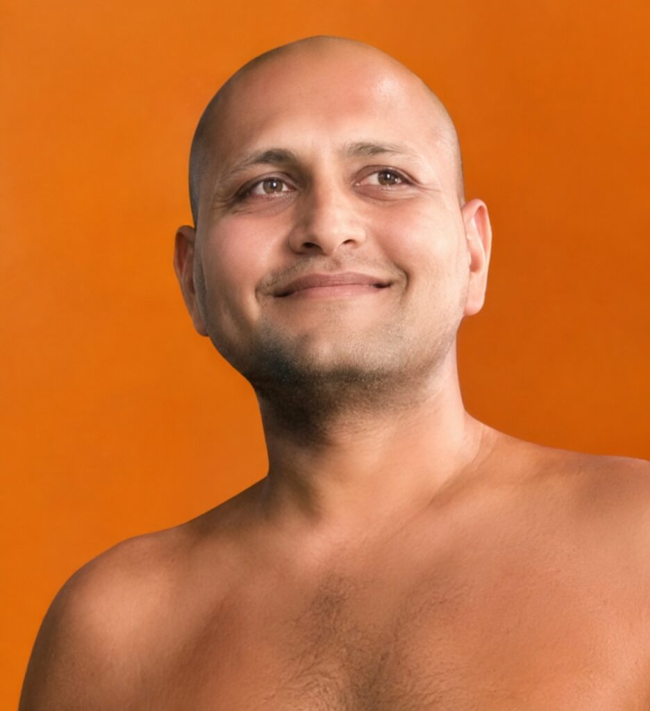 Smiling bald man with no shirt against an orange background, looking slightly to the side.