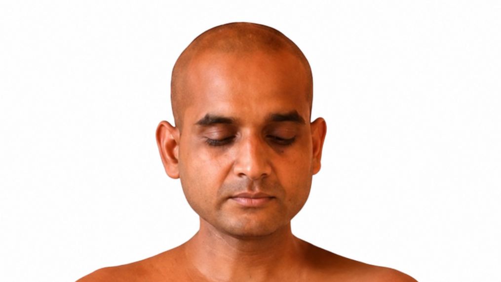 Close-up portrait of a bald man with eyes closed, neutral white background.