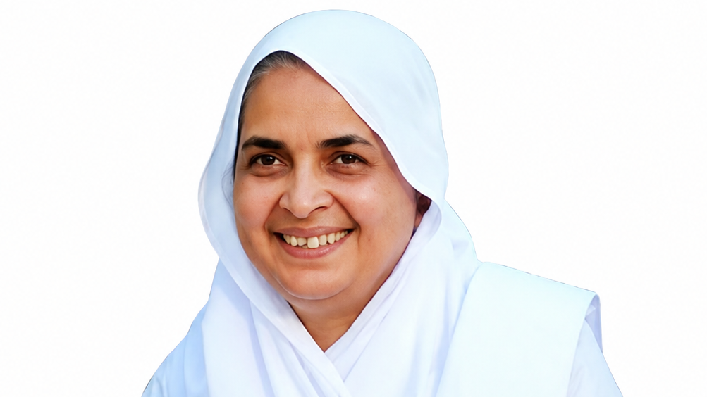 Smiling woman wearing a light blue hijab and matching medical uniform, facing the camera.