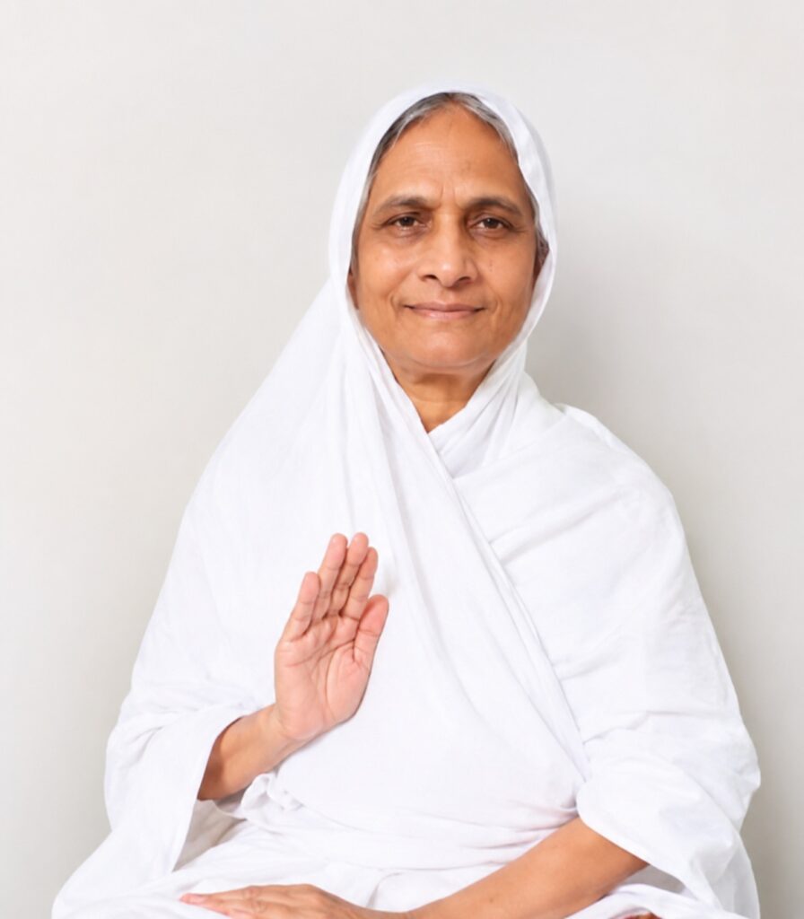 Older woman in a white headscarf and robe, smiling softly with her right hand raised in blessing.