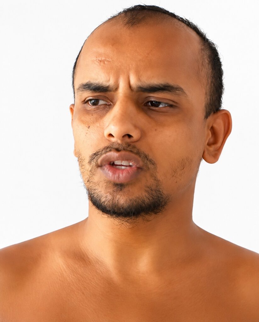 Close-up of a shirtless man with a furrowed brow, looking confused or thoughtful against a white background.