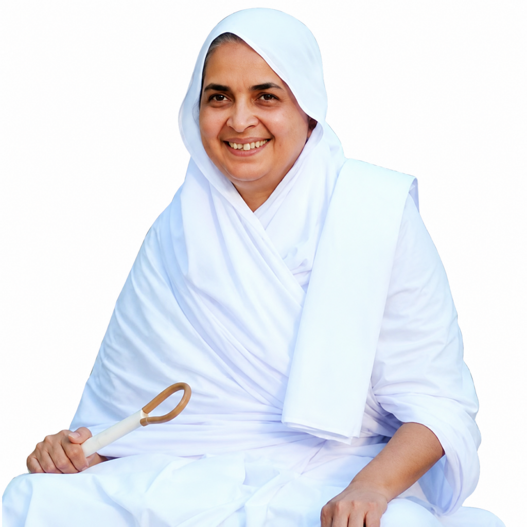 Smiling woman in a white hijab and robe, seated, holding a white curved object.