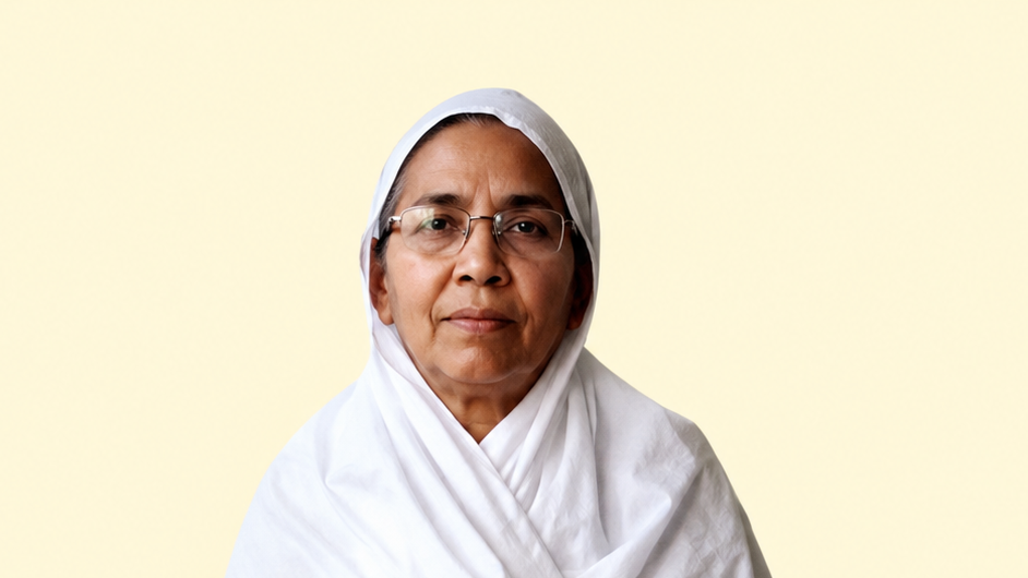 Portrait of an older woman wearing a white hijab and glasses, looking at the camera against a pale yellow background.