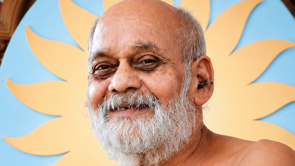 Smiling older man with a white beard and balding head, against a blue background with a large yellow sunburst behind him.