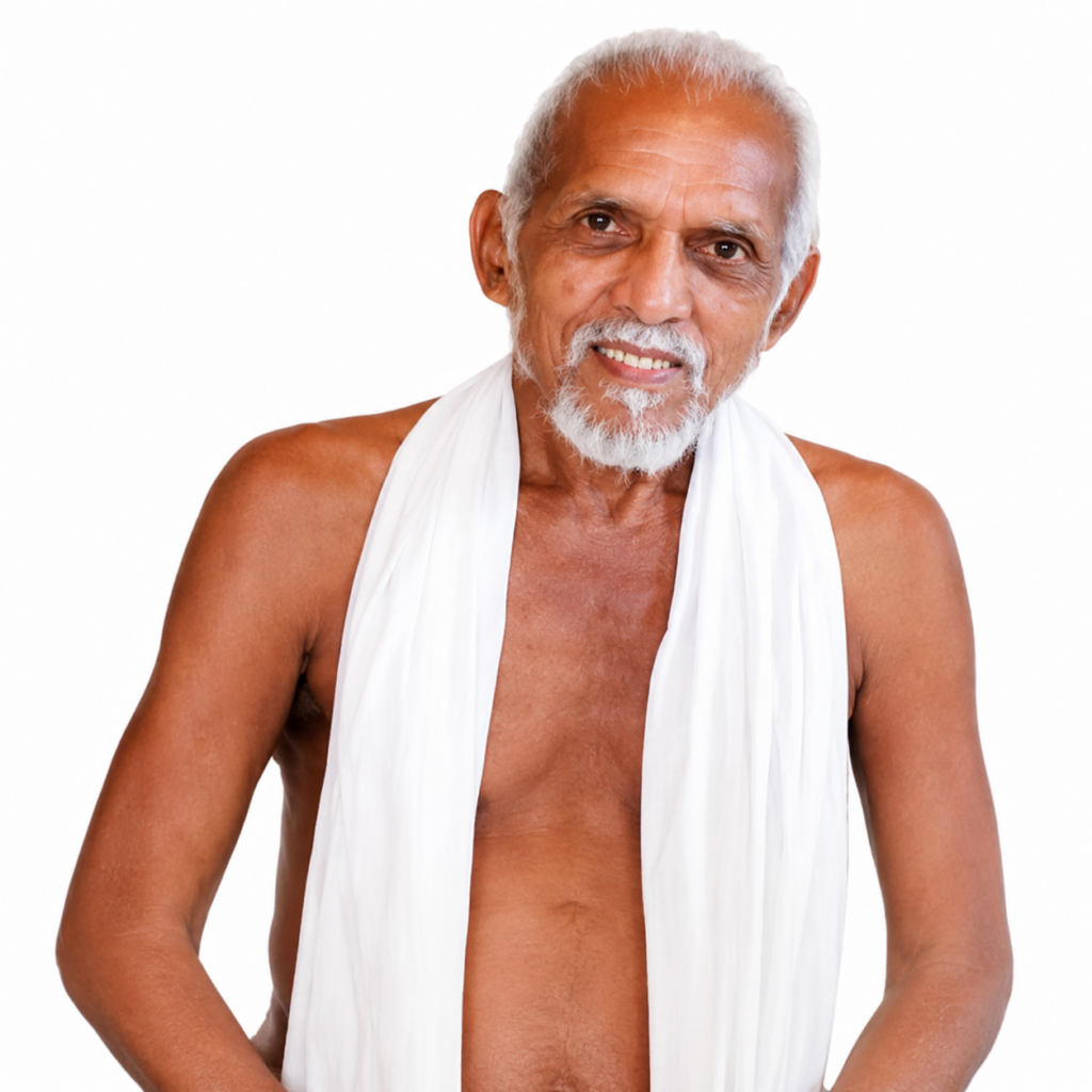 Older man with white hair and beard, shirtless with a white draped cloth, smiling at the camera.