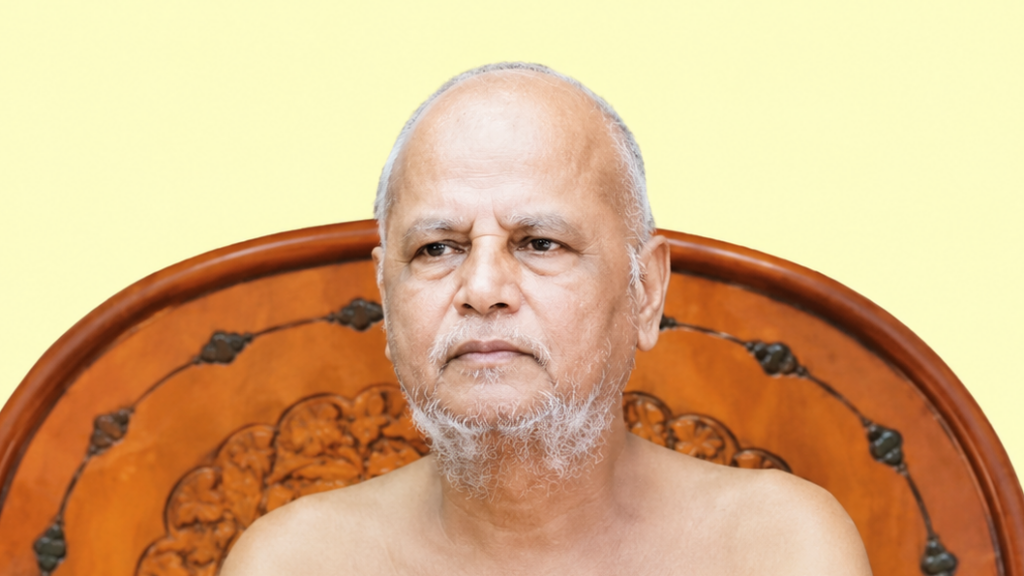 Portrait of an older man with a gray beard, shirtless, seated in front of a carved wooden headboard against a pale yellow background.