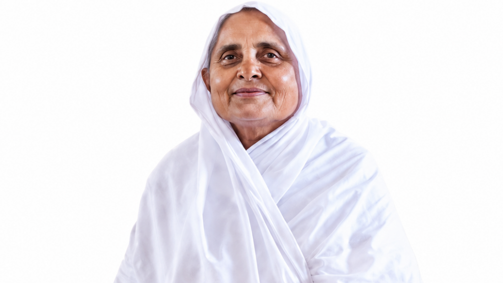 Portrait of a smiling elderly woman wearing a white hijab against a white background.