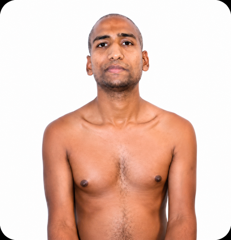 Front-facing portrait of a shirtless man with short hair and light stubble against a plain white background.