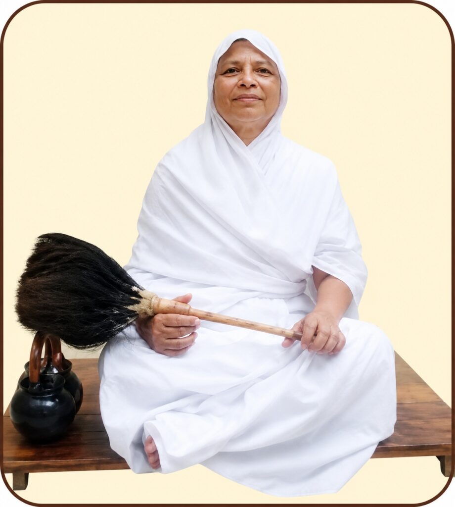 Person wearing a white robe and headscarf sits cross‑legged on a wooden bench, holding a large broom with a long handle.
