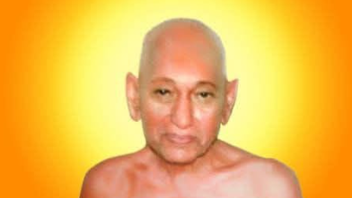Portrait of a bald Buddhist monk with bare shoulders and a calm expression, set against a bright orange halo background.